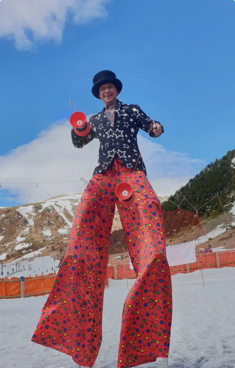 Amazing costumed stilt walker with 2 diabolos in Vall de Nuria Ski Resort, Pyrenees, Catalunya near Barcelona